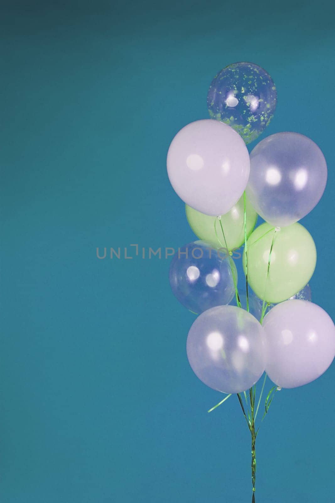 Balloons of light colors - white, light green, transparent on a blue background. by tewolf