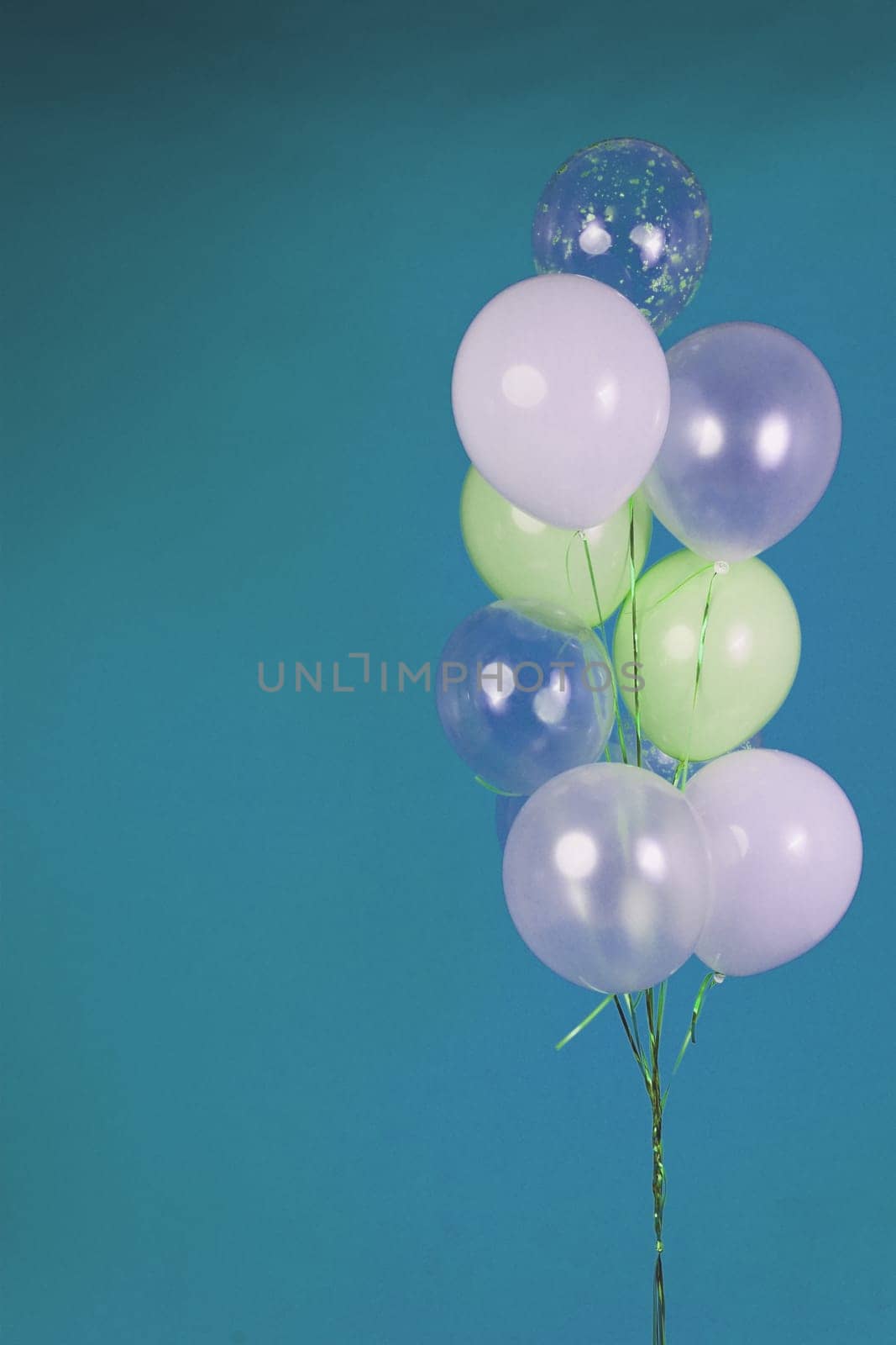 Balloons of light colors - white, light green, transparent on a blue background. by tewolf