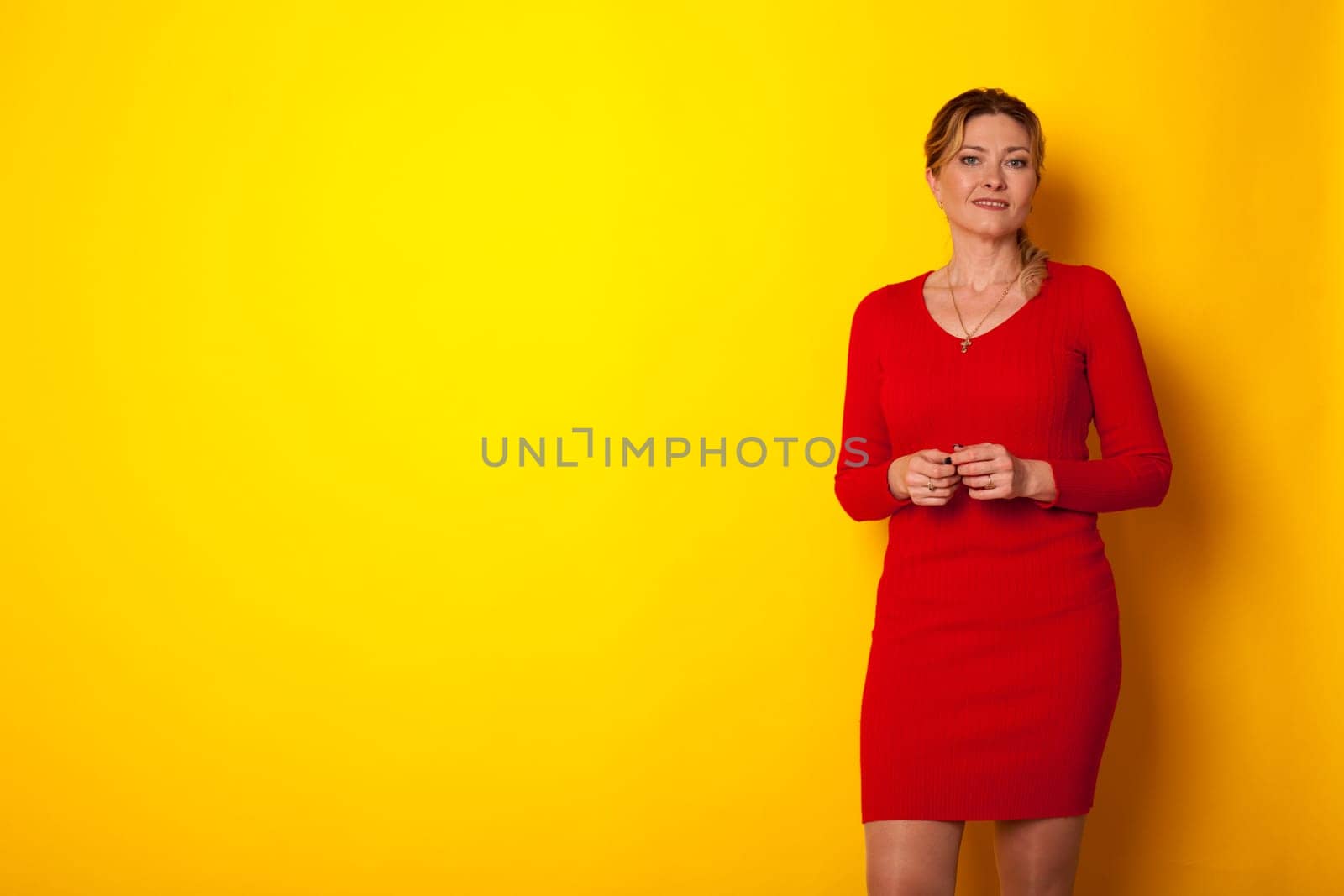 a woman in a red dress on a yellow background by Simakov