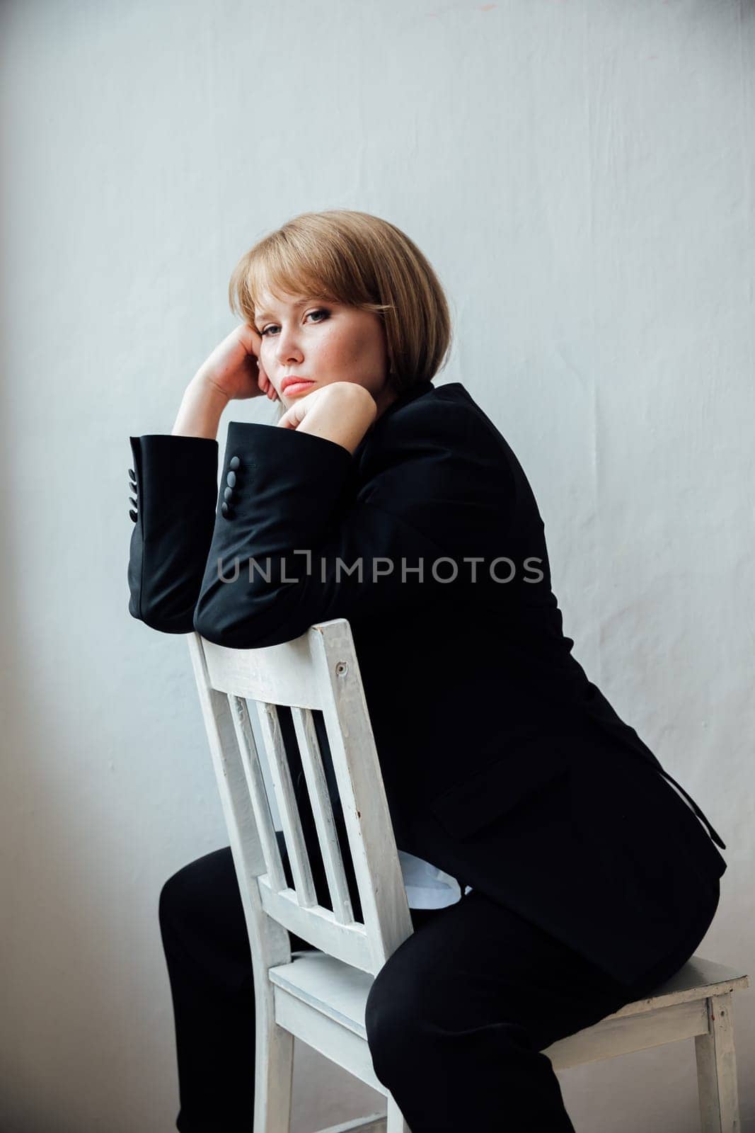 beautiful woman sitting on a chair in a bright room