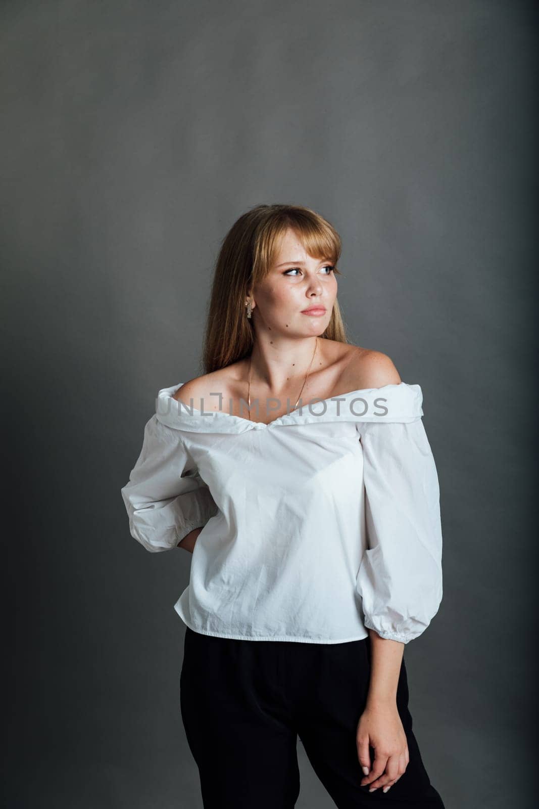 a beautiful woman posing on a gray background