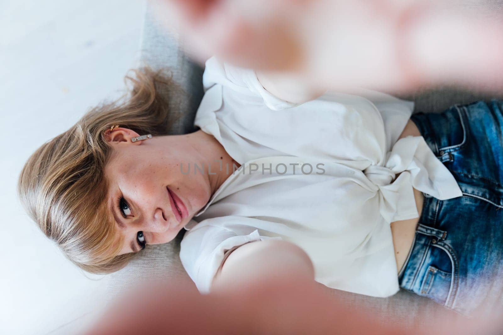 woman sitting on the couch in a bright selfie room