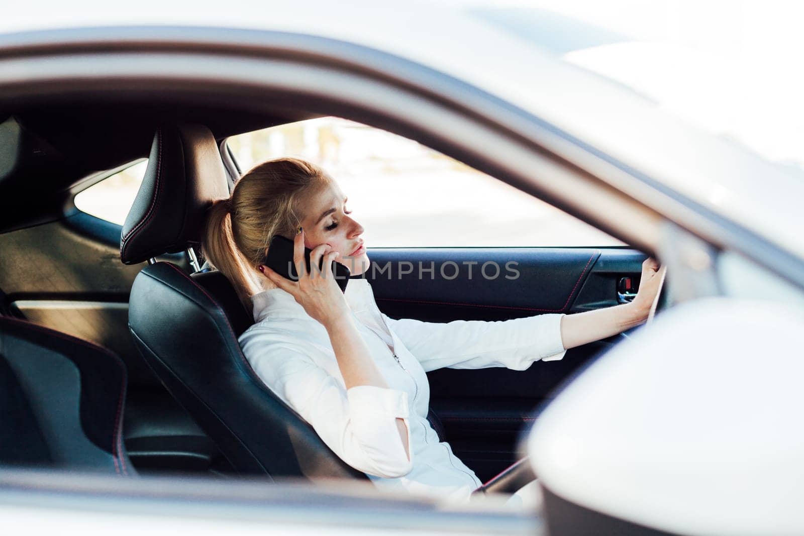 a woman driving talking on phone driver journey