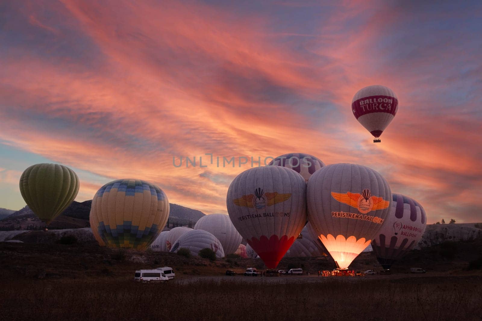 Landscape of Pamukkale park and a lot of hot air balloons in the morning sky . Turkey-october 2023. High quality photo