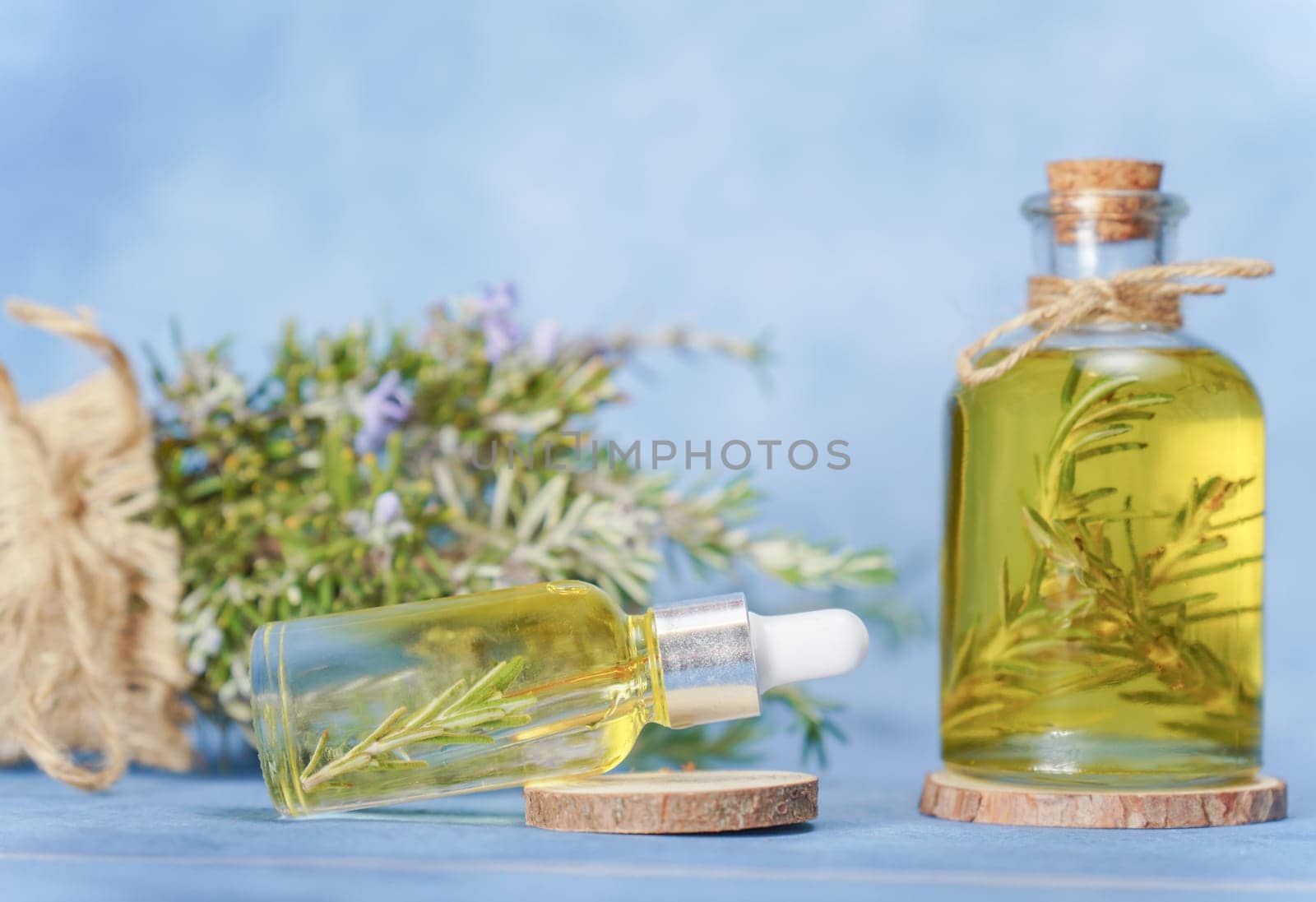 glass bottle and dropper with rosemary essential oil by joseantona