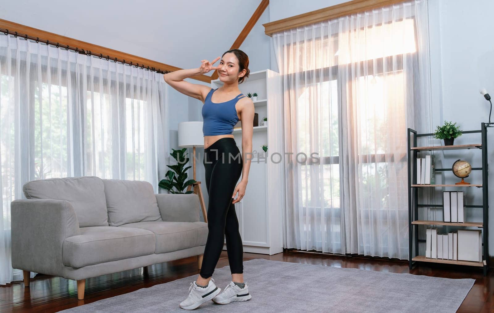 Full body asian woman in sportswear portrait, smiling and posing cheerful gesture. Home workout training with attractive girl engage in her pursuit of healthy lifestyle. Vigorous