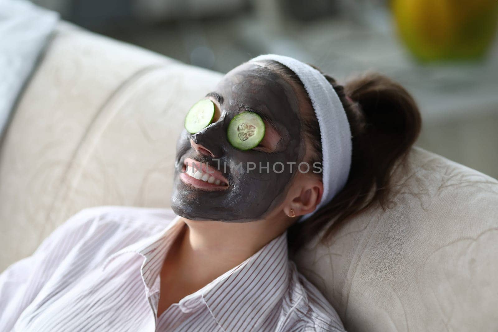 Woman makes gray clay facial mask at home by kuprevich