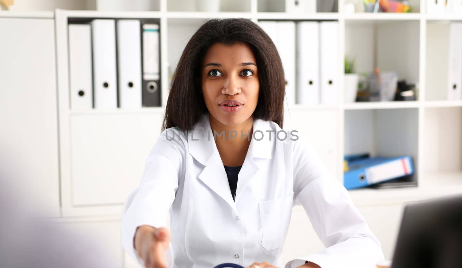 Doctor shake hand as hello with patient in office closeup. Welcoming friend introduction or thanks gesture consultation work thankful client talk team trust communication teamwork deal concept