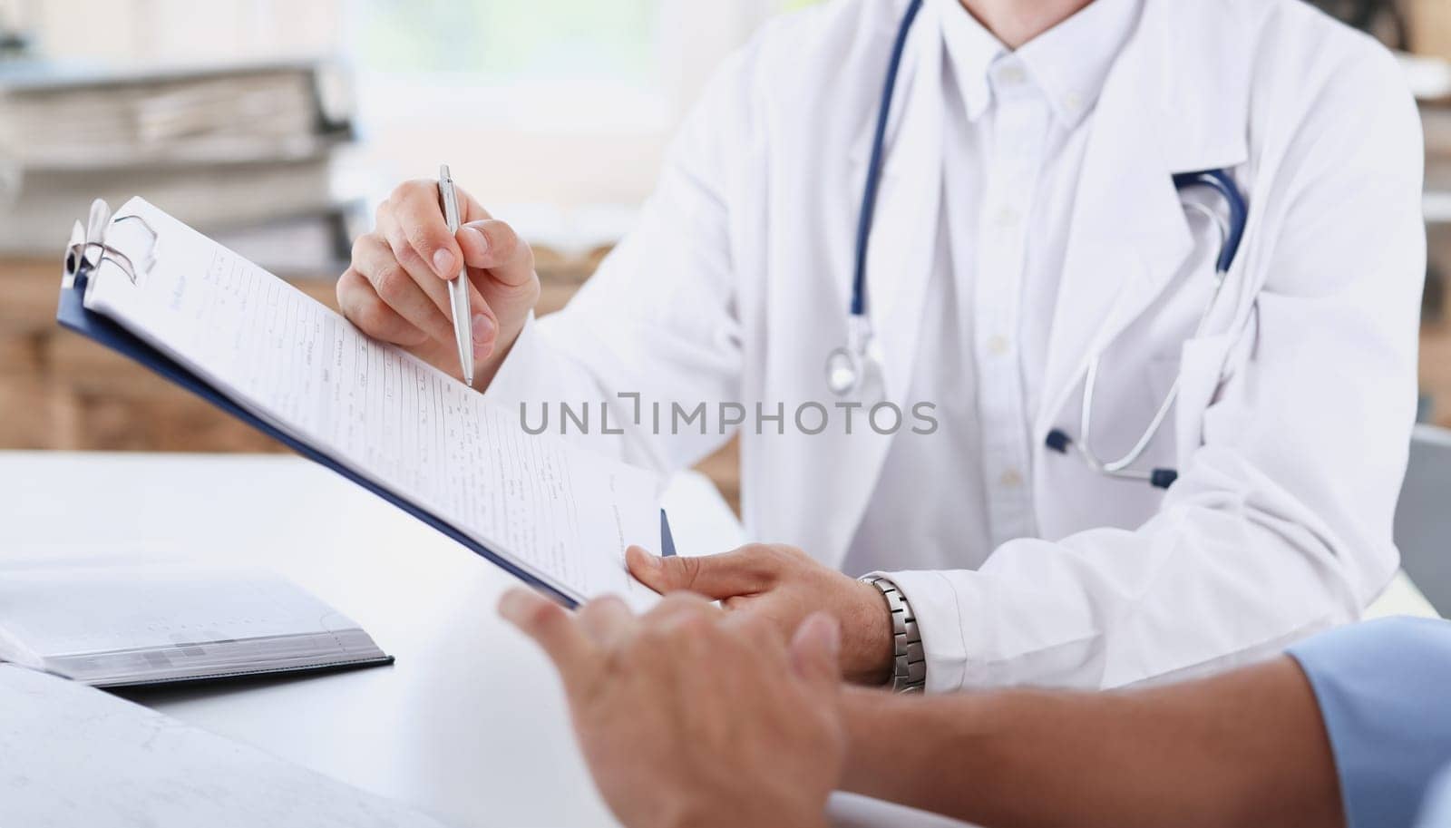 Male doctor hand hold silver pen and by kuprevich