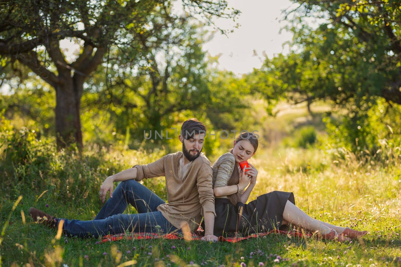 Young couple in nature, girl with phone by zokov