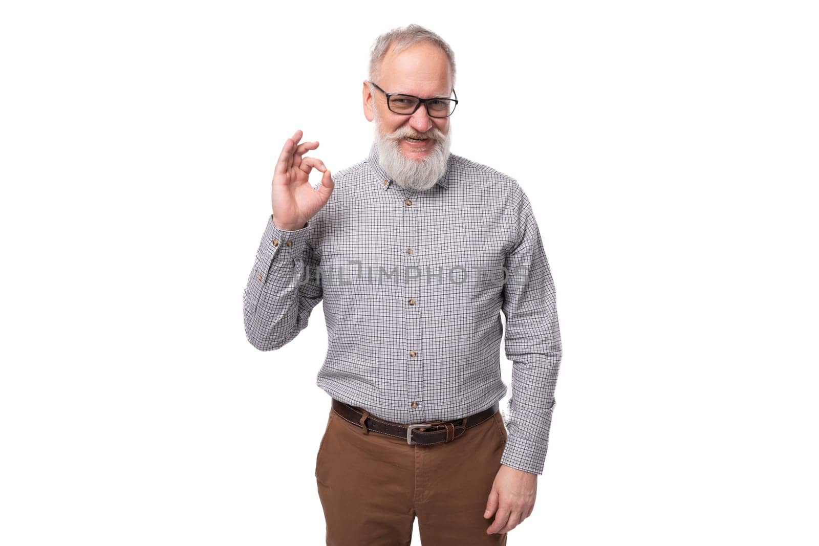 stylish pensioner man with a beard and mustache in a shirt and trousers.