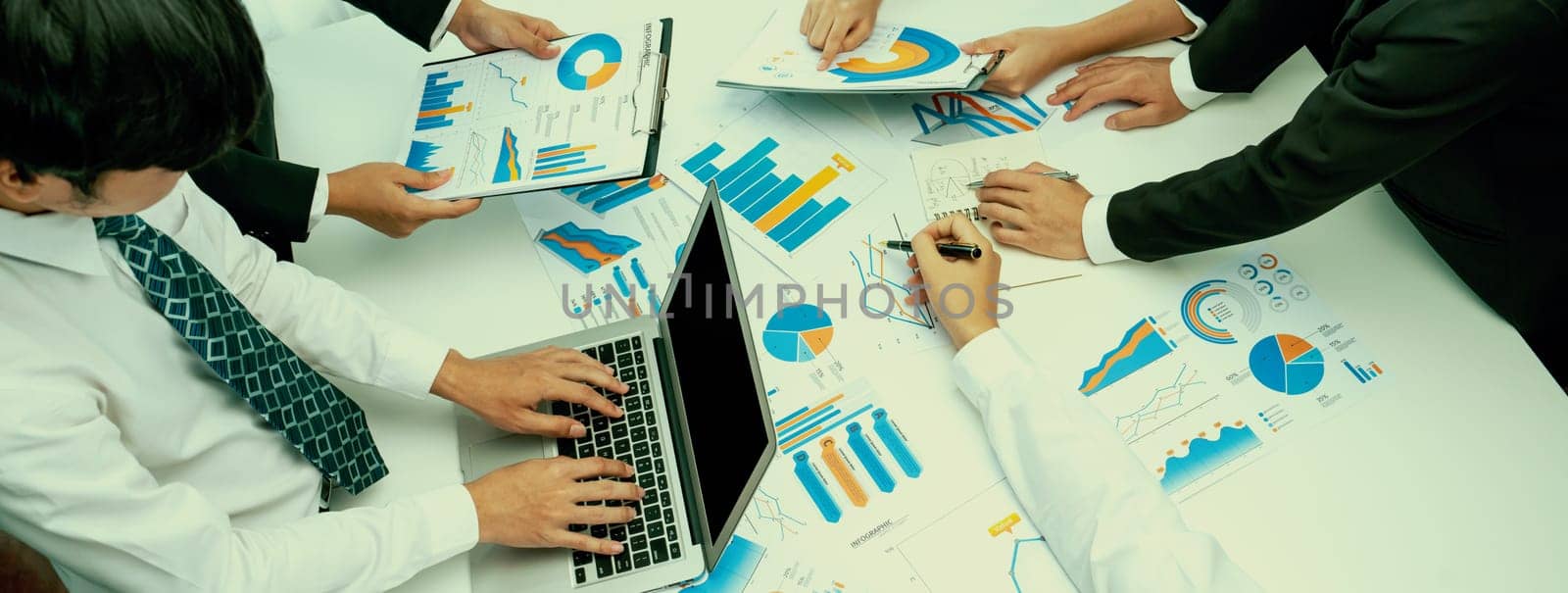 Business people in group meeting in formal attire share idea discussing report for company profit in creative workspace for start up business shot in close up view on group meeting table . Oratory .