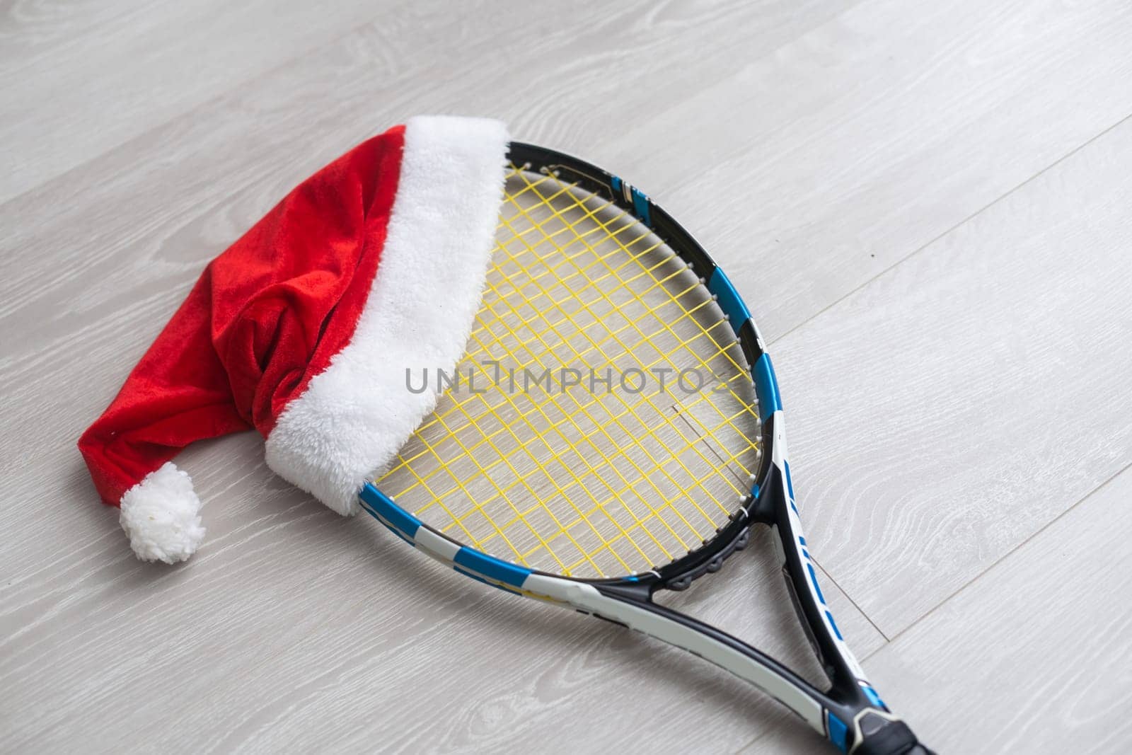 santa hat on tennis racket on white background.