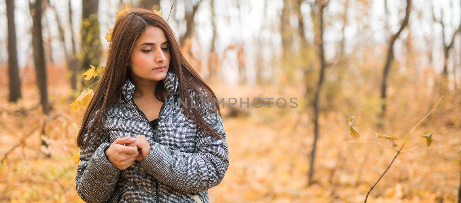 Close-up portrait of diversity young beautiful confident Indian Asian woman in fall outdoor copy space banner mockup. Happy and natural smiling female. Generation z and gen z youth concept by Satura86