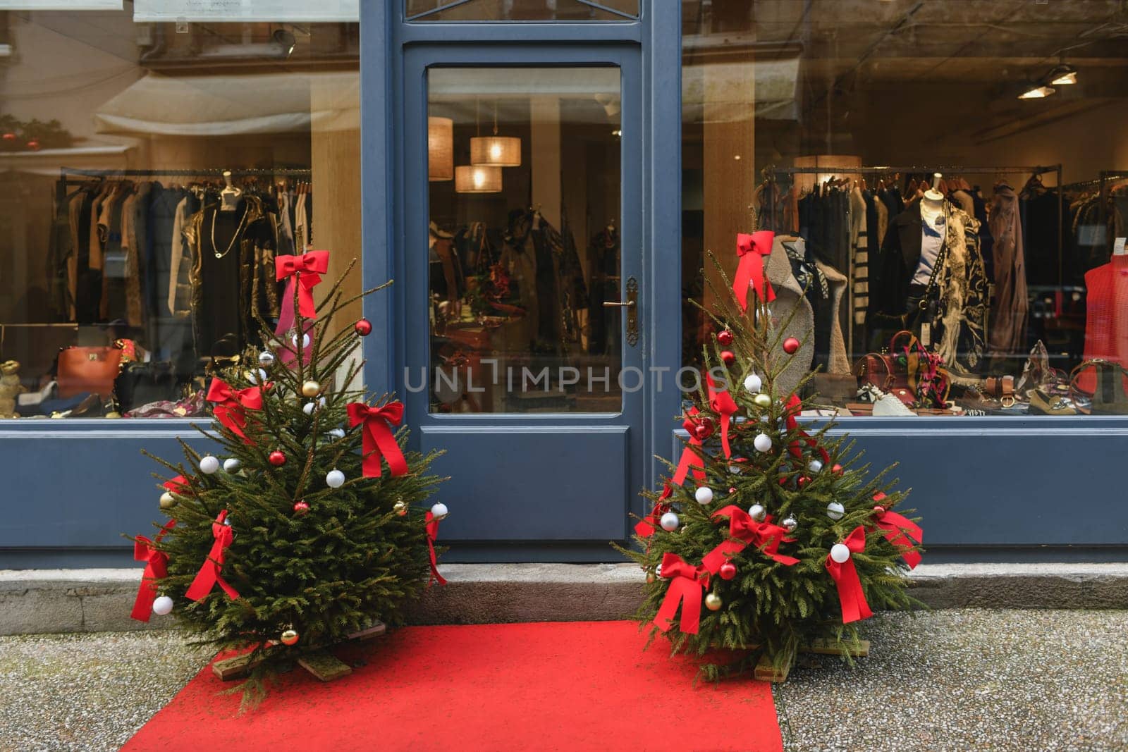 The store facade is decorated with Christmas trees.