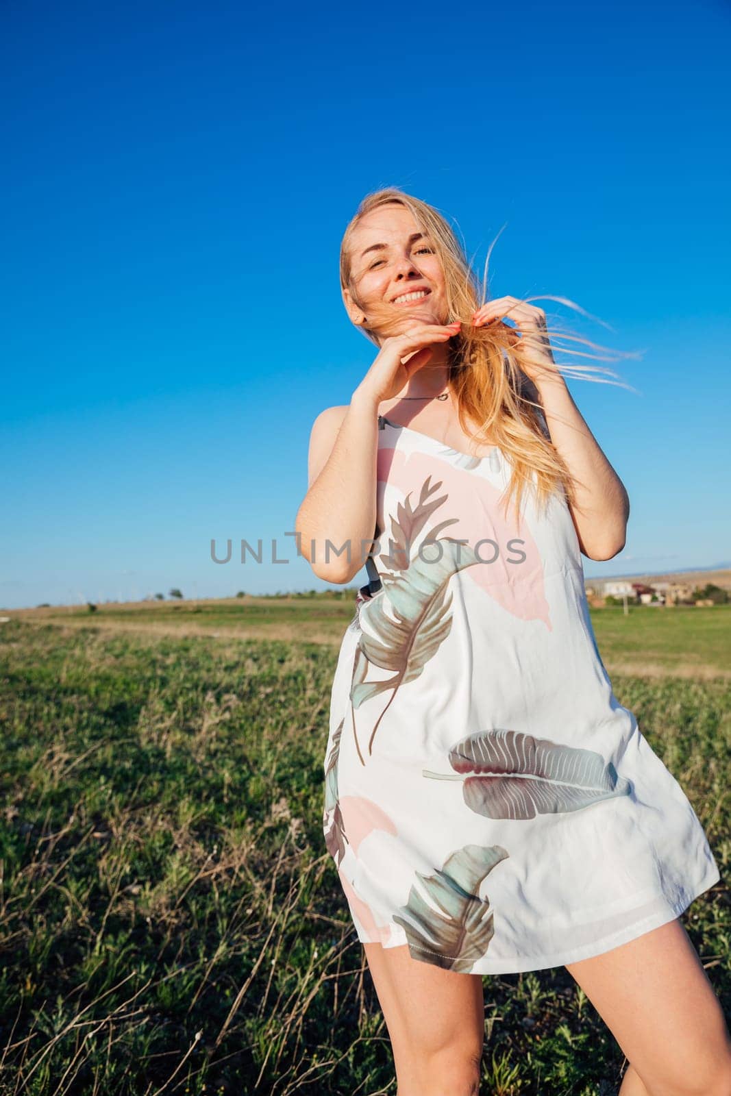a walk blonde woman in nature on the field travel