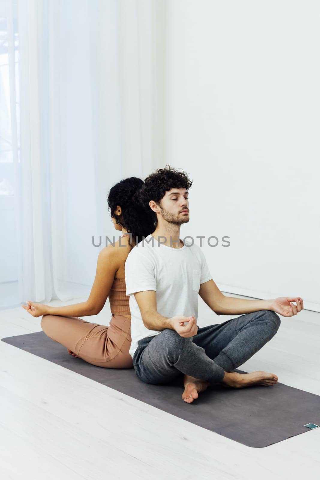a stretching exercises flexible body acrobatic poses yoga woman and man do gymnastics warm-up