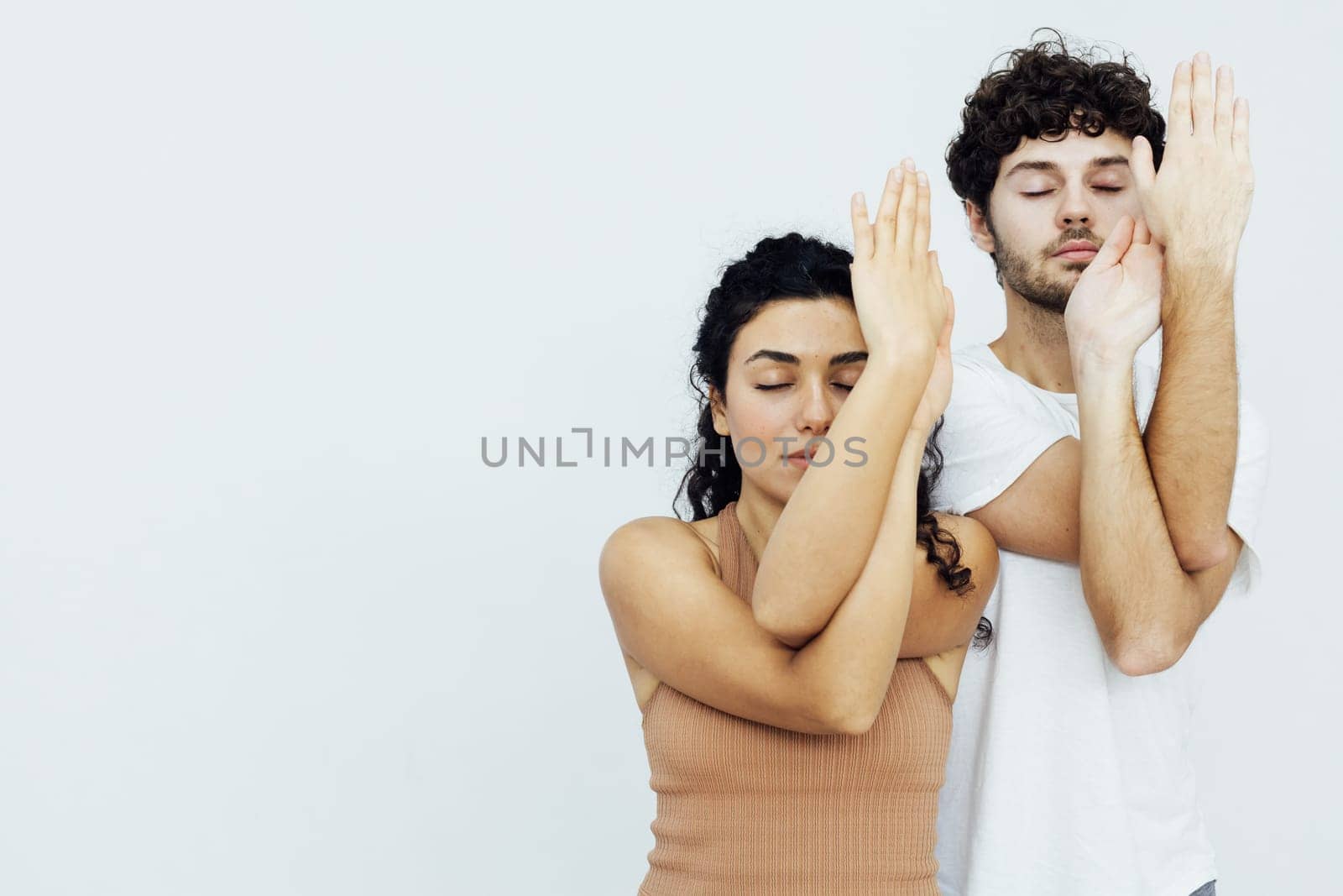 flexible body acrobatics yoga poses woman and man do gymnastics warm-up exercises stretching by Simakov