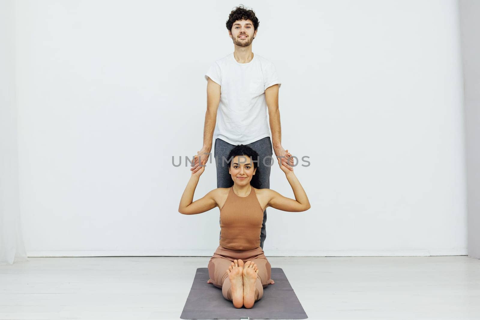flexible body acrobatics yoga poses woman and man do gymnastics warm-up exercises stretching by Simakov