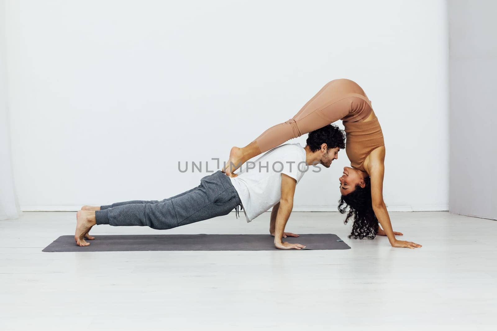a yoga poses woman and man do gymnastics warm-up exercises asana flexible body