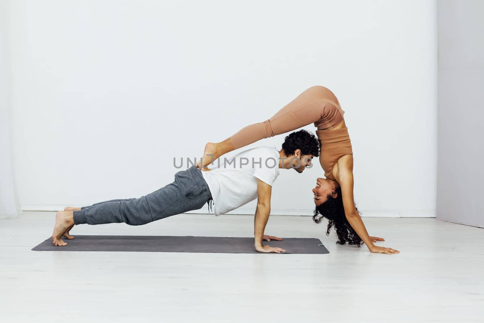 yoga poses woman and man do gymnastics warm-up exercises asana flexible body by Simakov