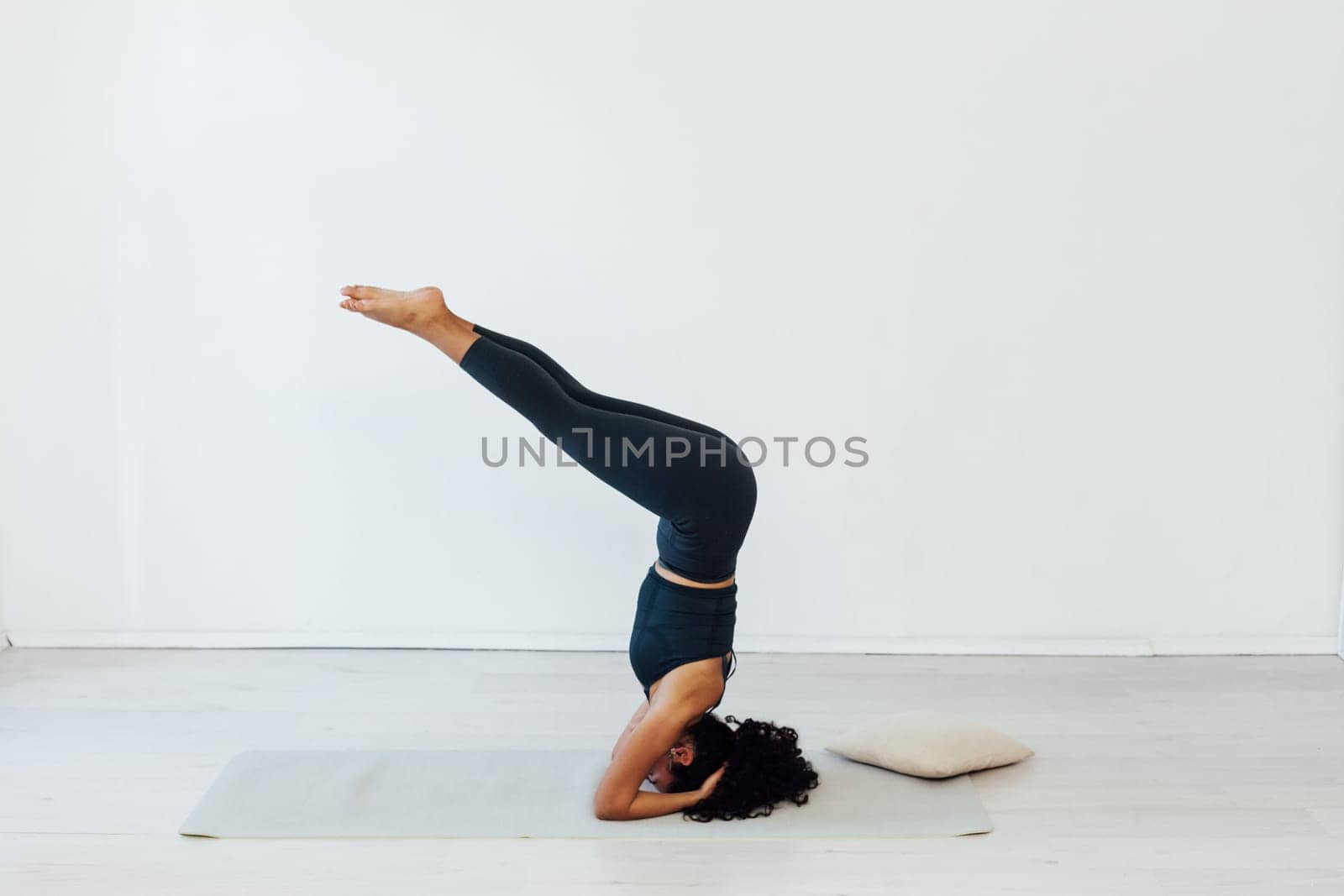 exercises a woman stands on her head doing yoga relaxation classes stretching postures