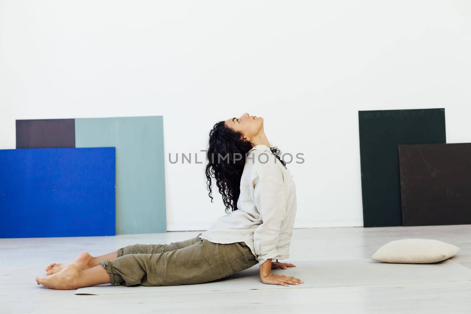 stretching woman doing yoga lotus pose exercises relaxation classes by Simakov