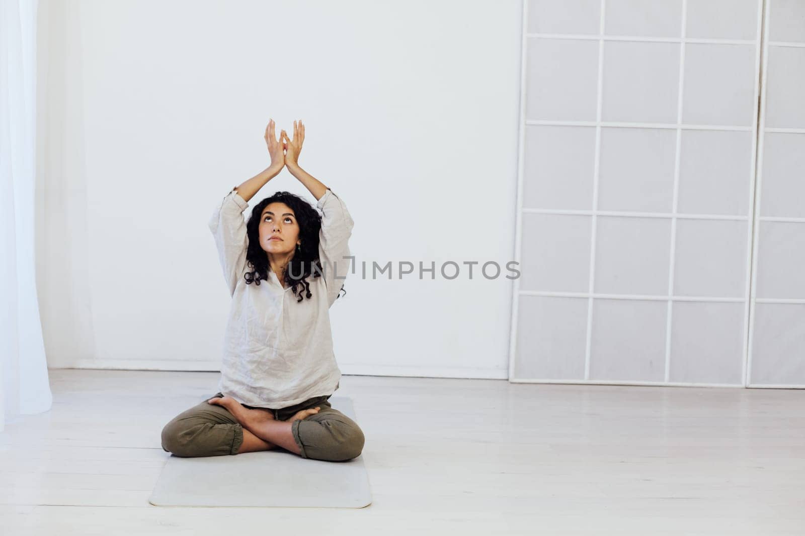 a woman doing yoga lotus pose relaxation exercises