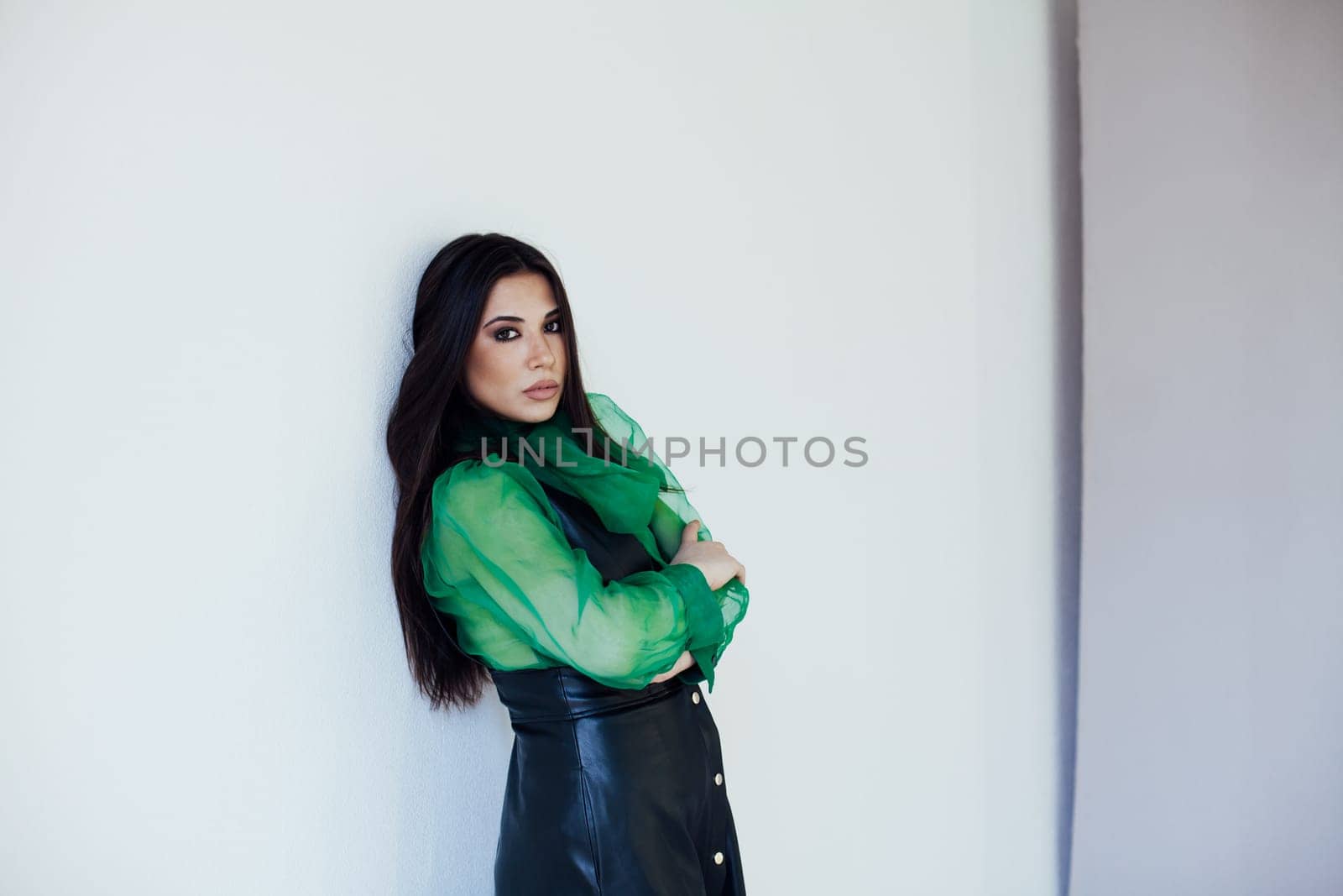 beautiful woman standing on a white background in a bright room