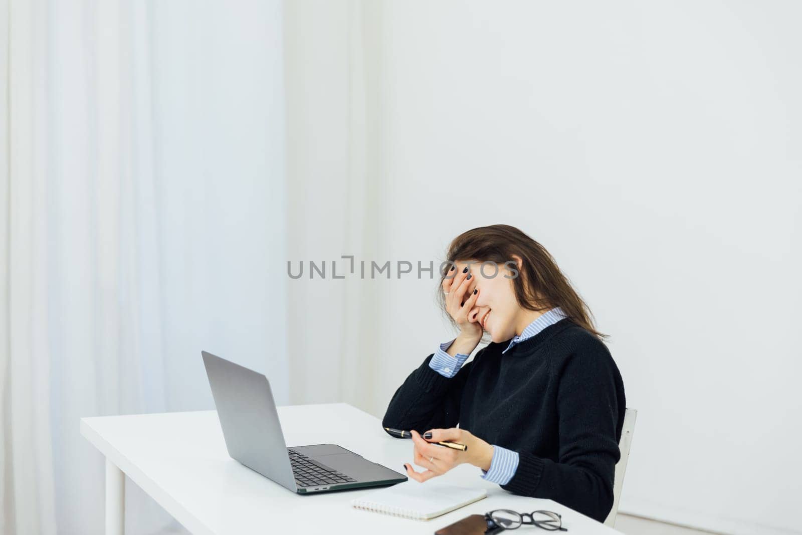 woman is tired of talking at the computer in the office remote work internet online