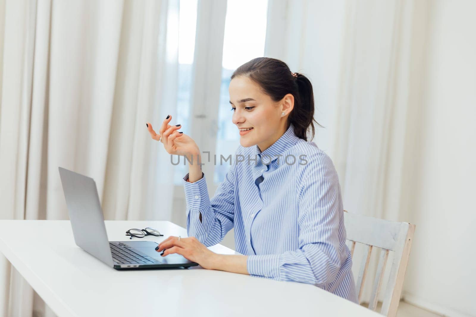 a woman communicates via skype with laptop at remote work internet conversation online communication