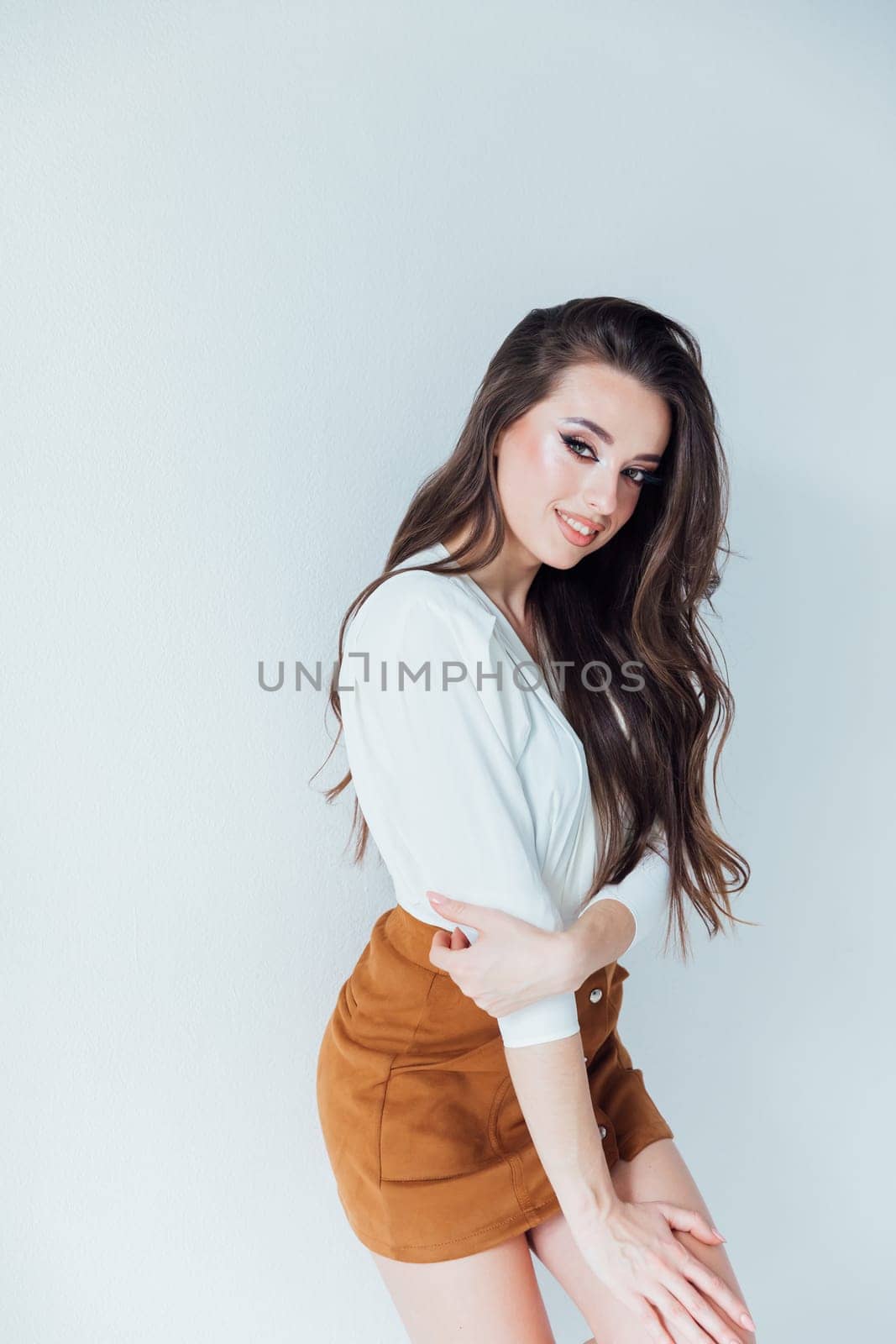 a beautiful fashionable woman on a white background in a bright room