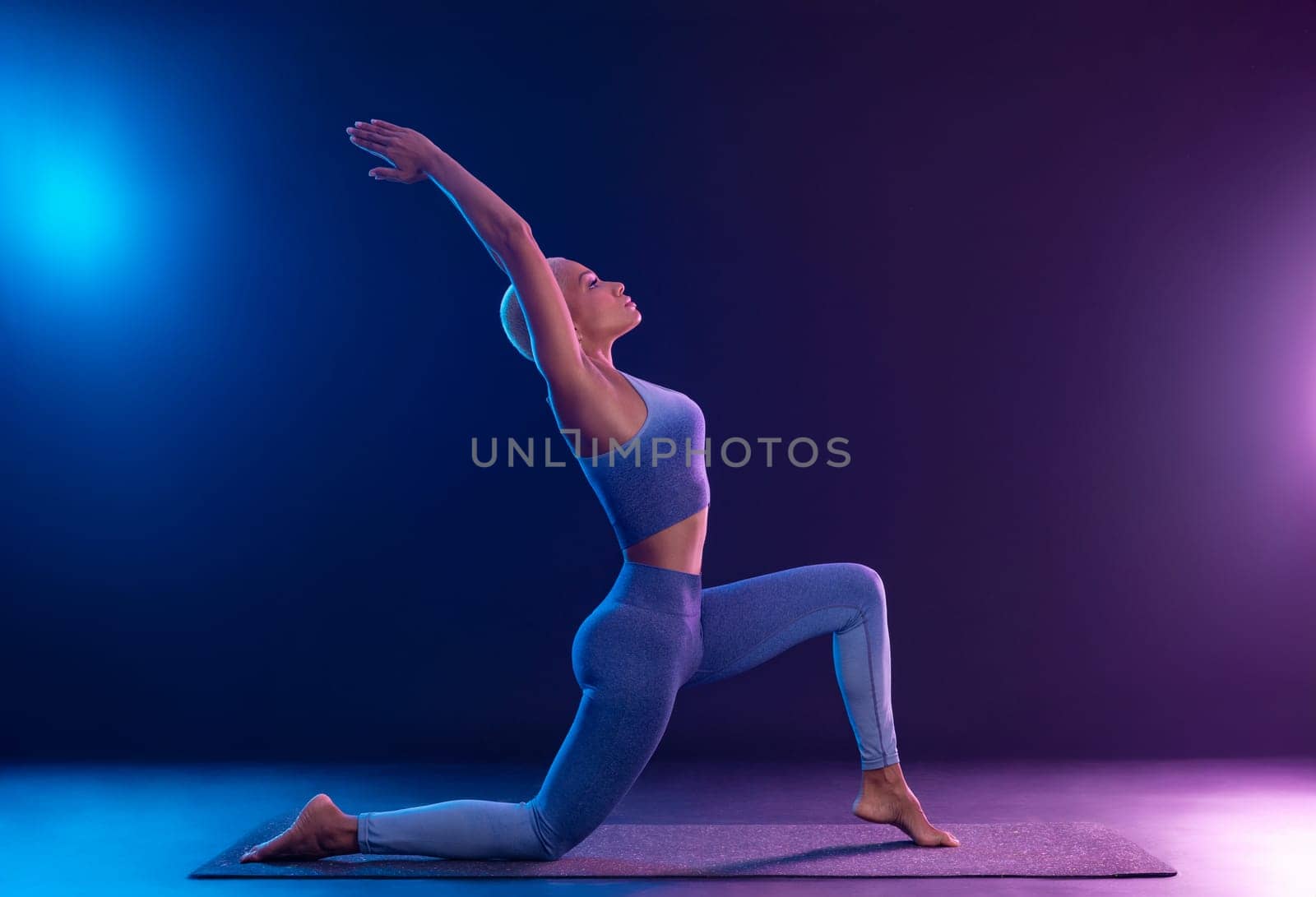 Download photo for yoga classes ads. Yoga asana Indoor. Sports recreation. Beautiful young woman in yoga pose. Individual sports.
