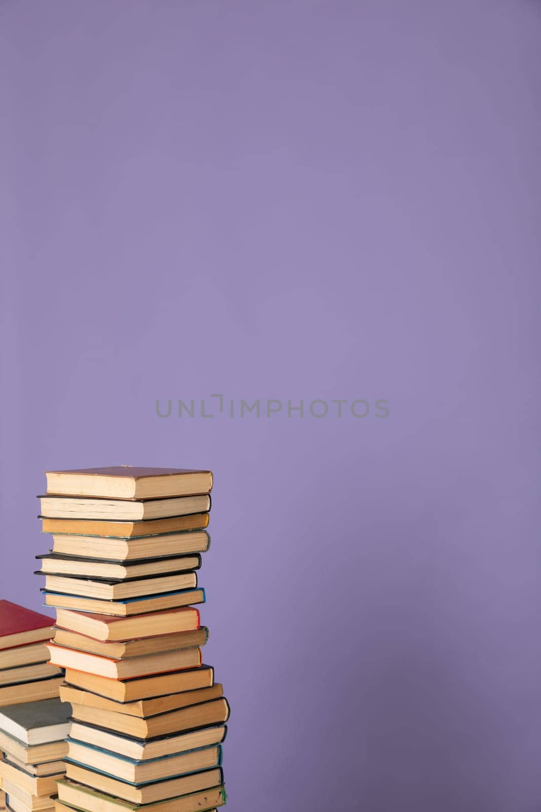 stack of books in the library on a purple background training education science
