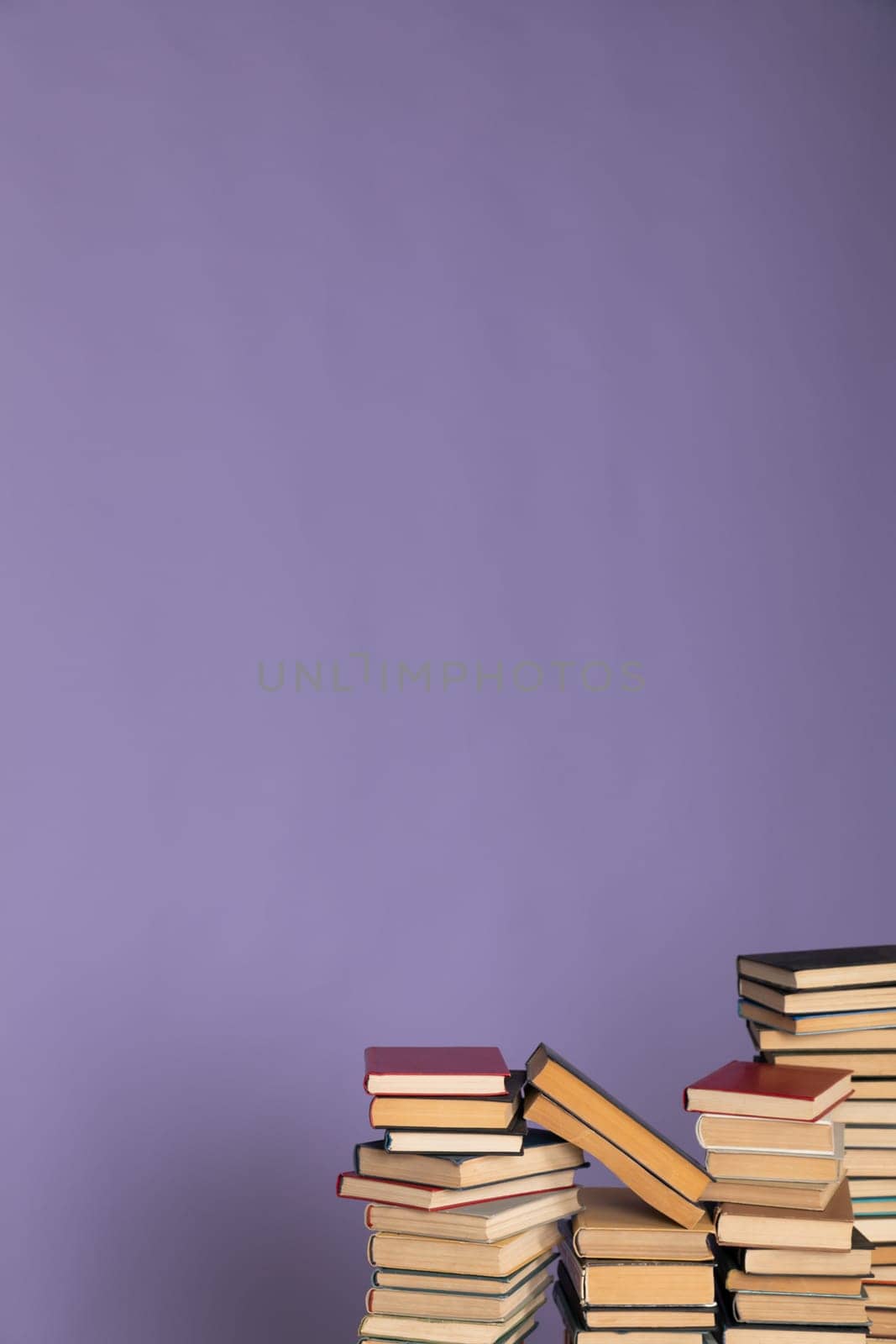 a stack of books in the library on a purple background training education science by Simakov