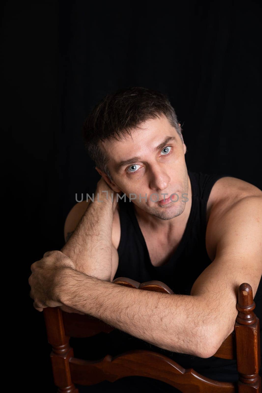 portrait of a man in dark room on a black background