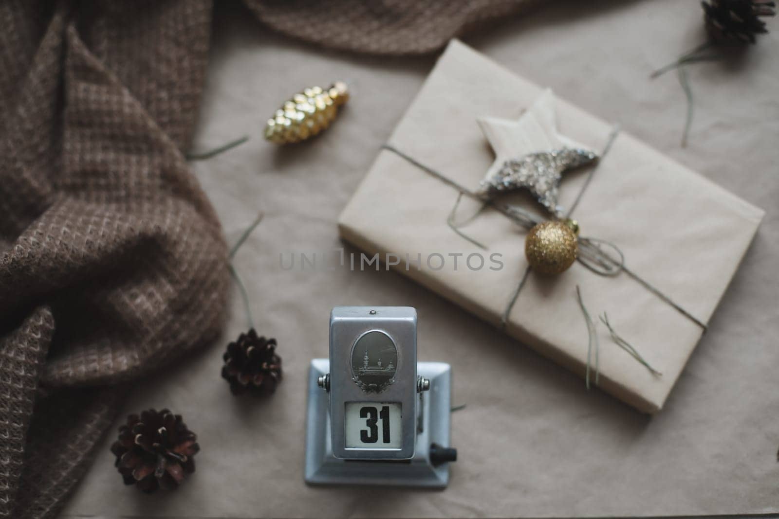 Christmas composition. Gift, fir tree branches, balls on craft paper background. Christmas, winter, new year concept. Flat lay, top view, copy space.