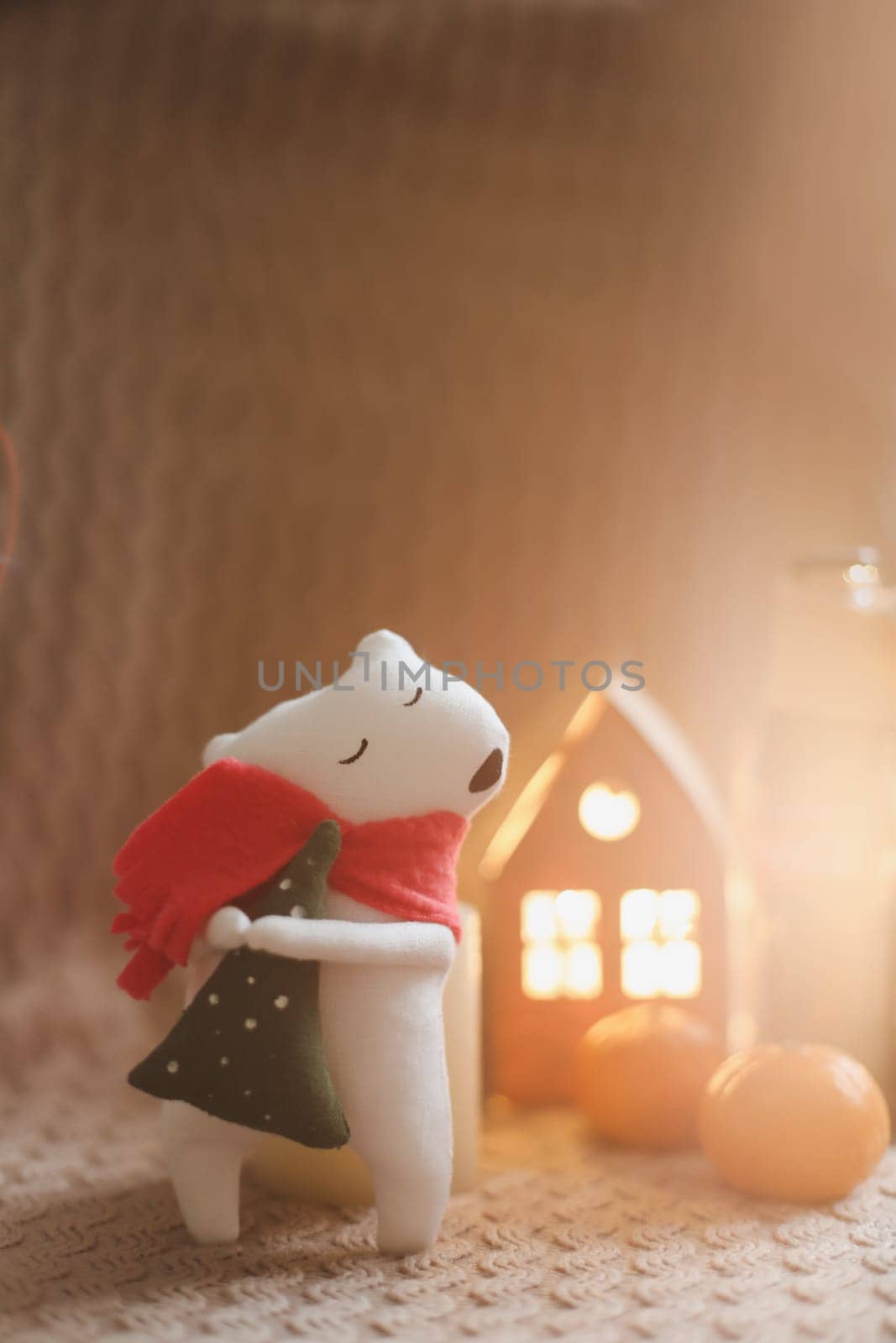 Christmas mood concept. Cozy composition with plaid, toy bear, tangerines and traditional festive decorations by paralisart