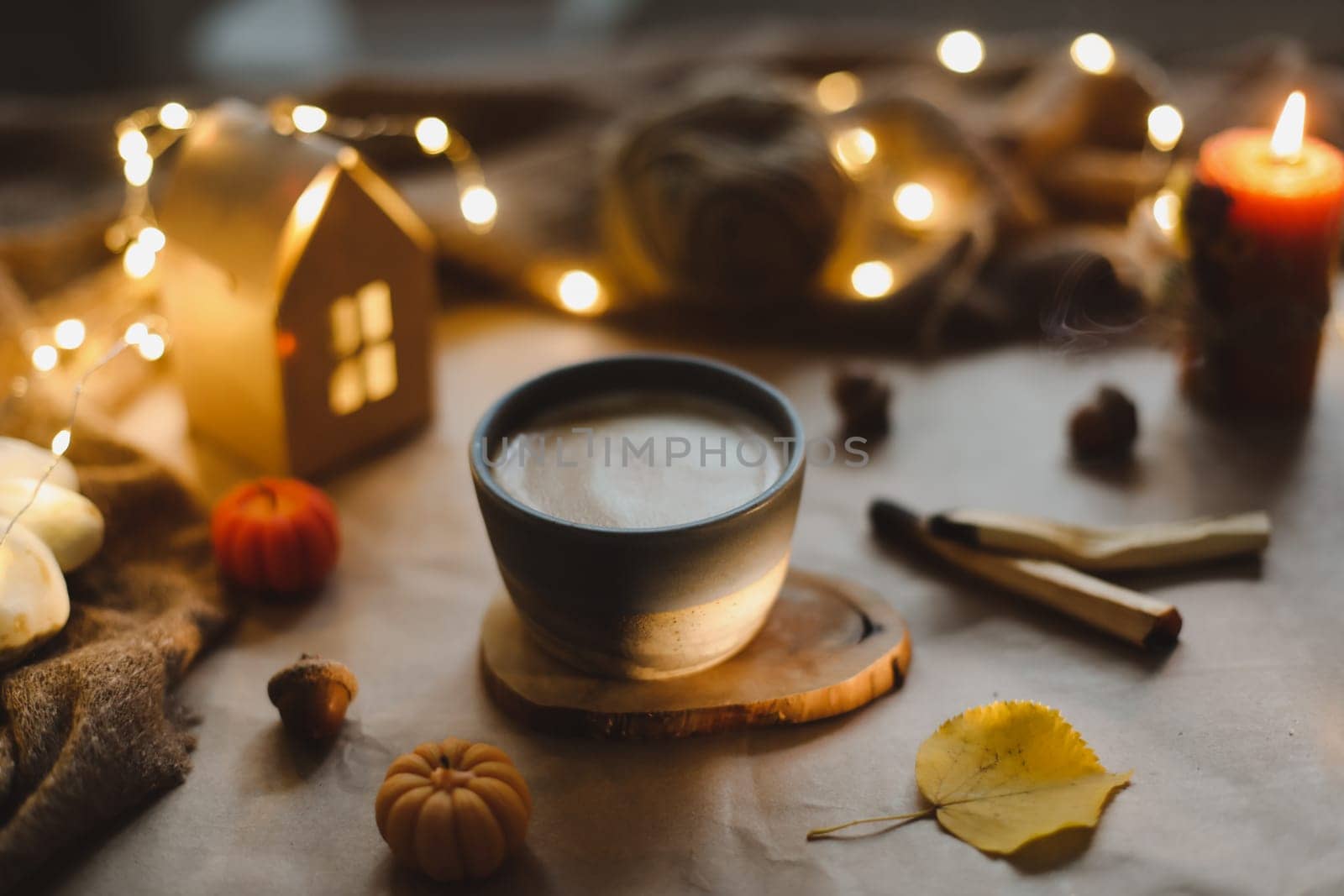 Autumn still life details in cozy home interior with a cup, candles, plaid. Hygge home decor. Autumn banner