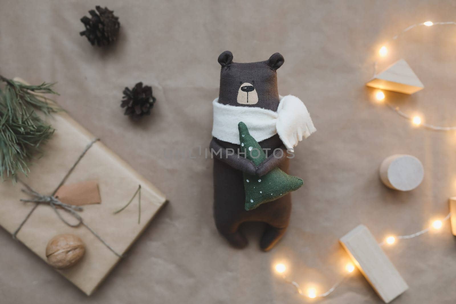 Christmas composition. Toy Teddy Bear, a gift, fir tree branches and decorations. Christmas, winter, new year concept. Flat lay, top view, copy space.