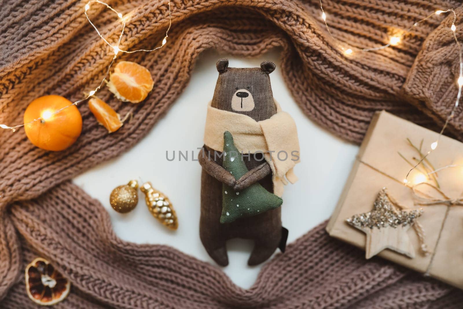 Christmas composition. Toy Teddy Bear, a gift, fir tree branches and decorations. Christmas, winter, new year concept. Flat lay, top view, copy space.