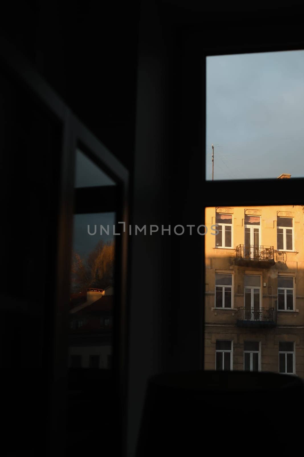 View of the city from the window. Tile roofs over historical city center. Travel concept