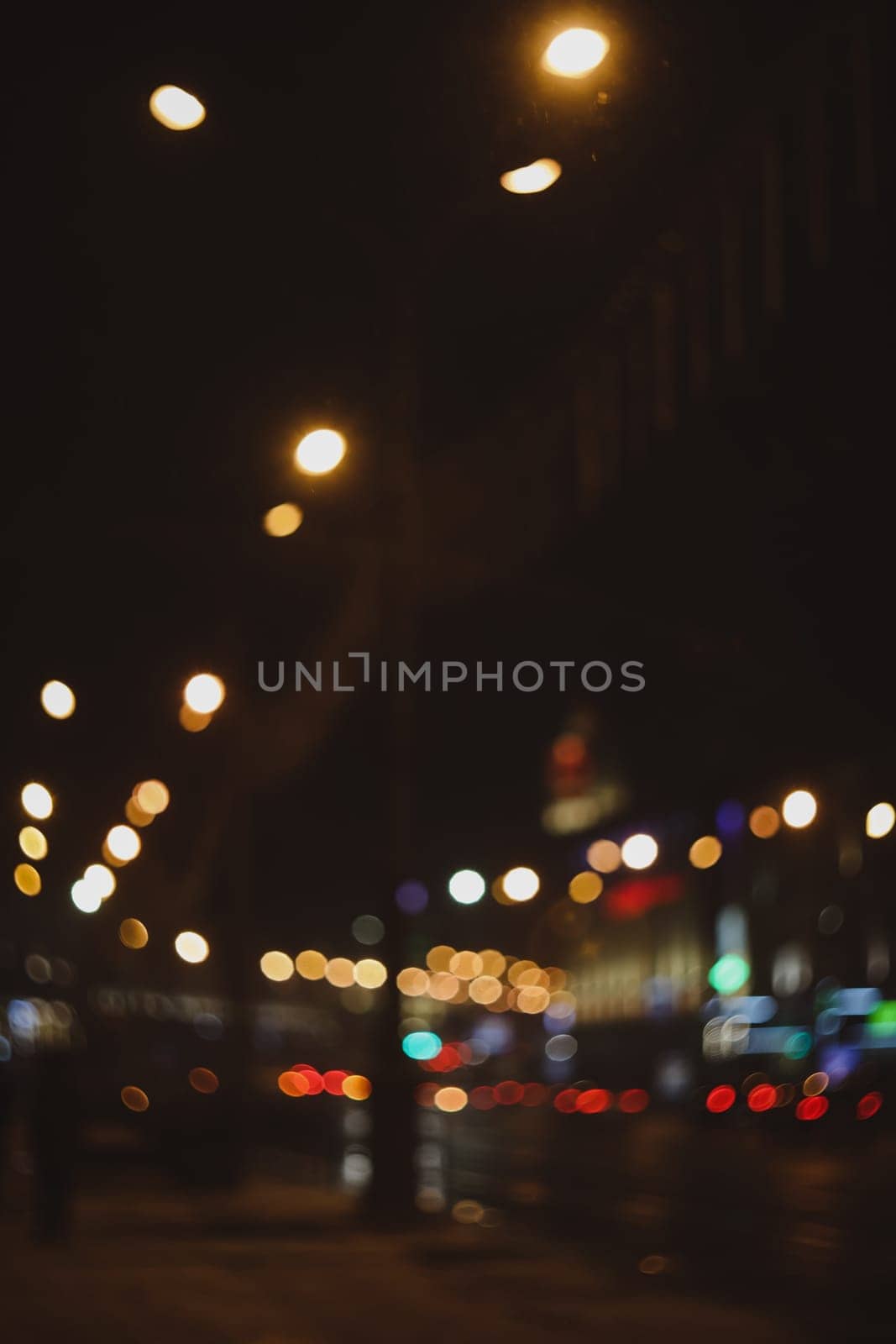 Colorful lights of urban city surrounding moving and blurred by motion. the light trails on the street. Blurred defocused lights of city traffic by paralisart