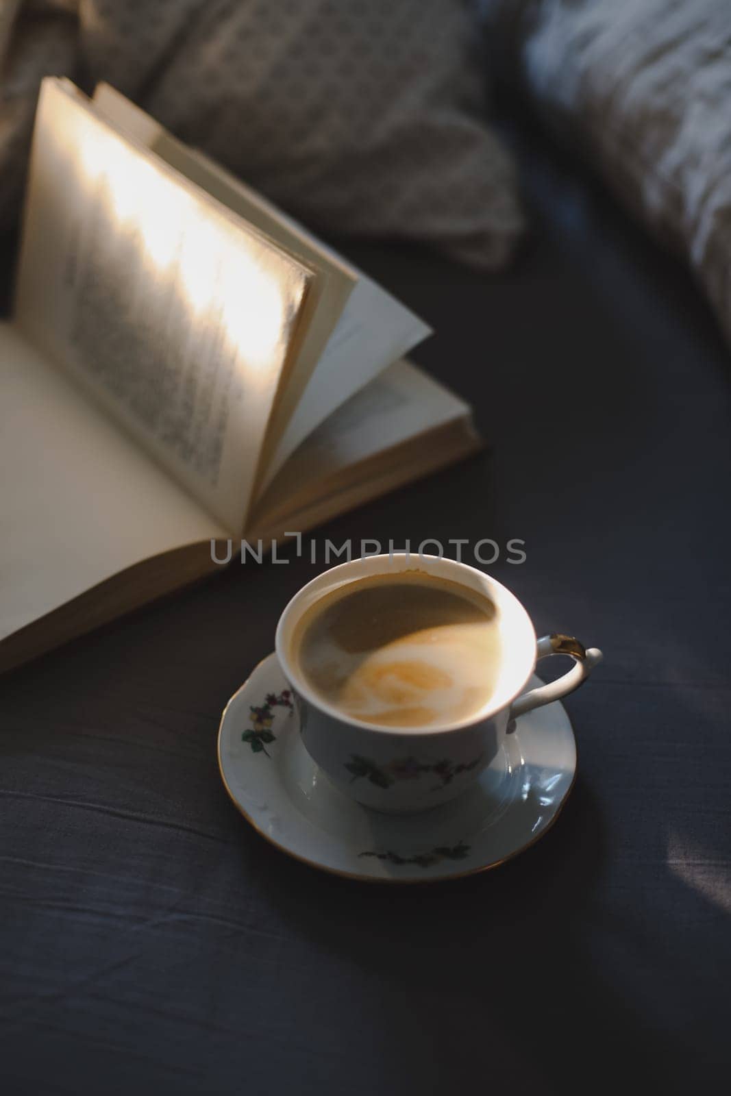 a cup of coffeeand a book in bed. Coffee in a cozy interior home background, Lifestyle concept. by paralisart