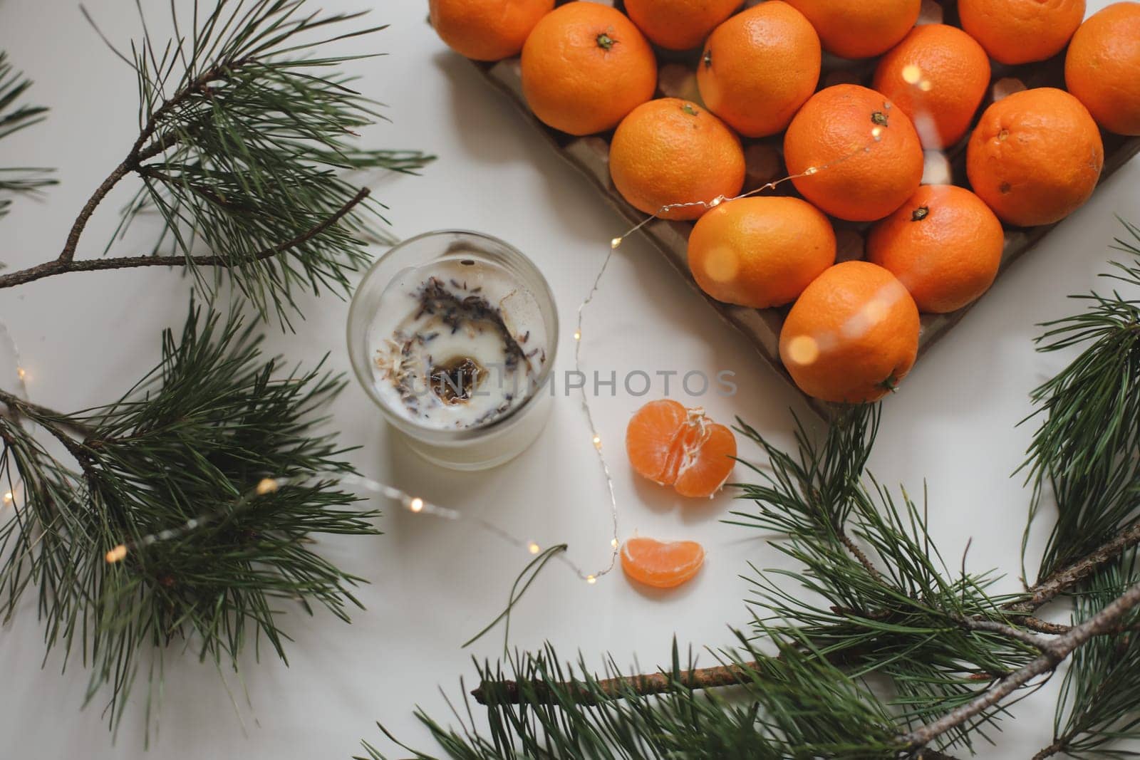 Candle, tangerines and pine. Christmas background with fir tree branches and tangerines merry christmas and happy new year. High quality photo