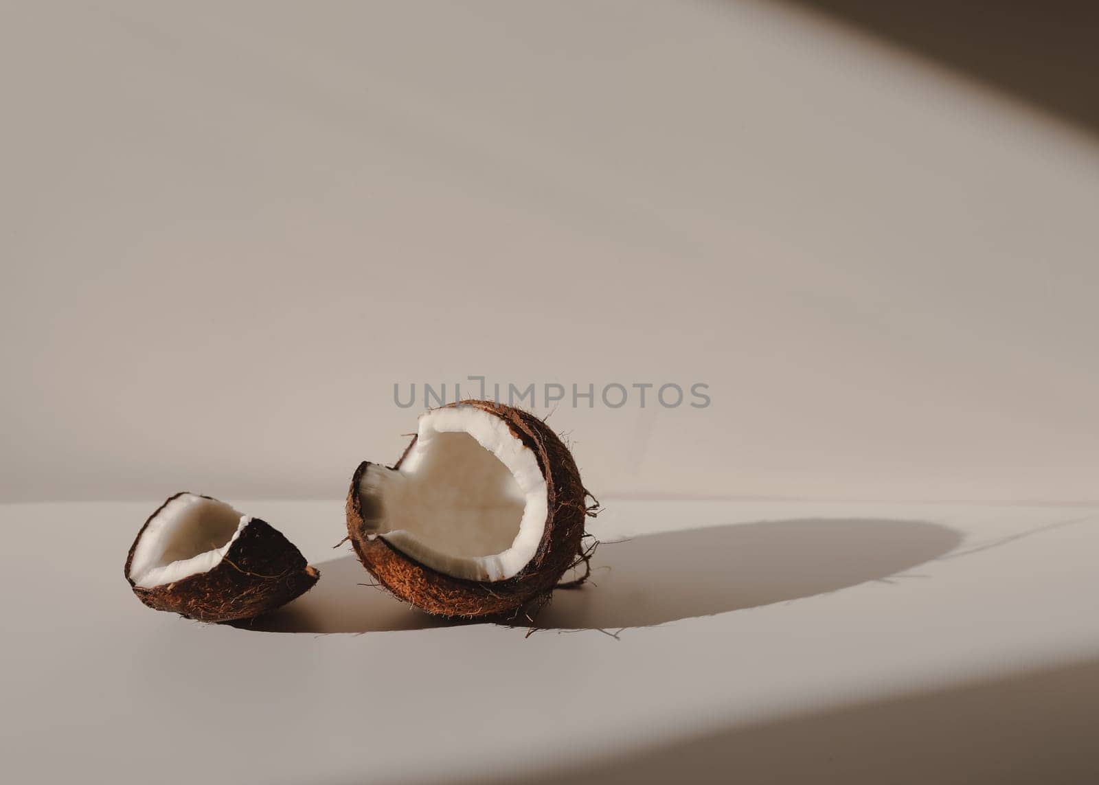 opened coconut pieces isolated on white background by paralisart