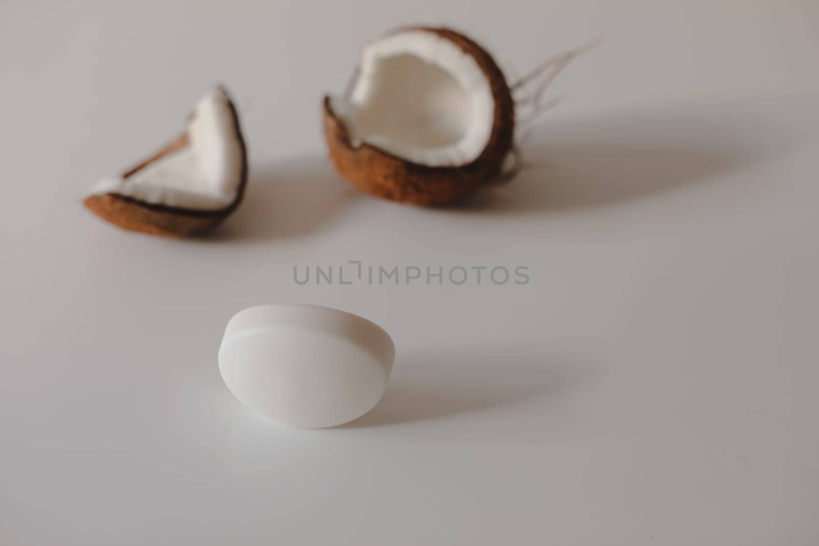 Natural herbal soap with coconut oil. Handmade soap bar and coconut on white background.