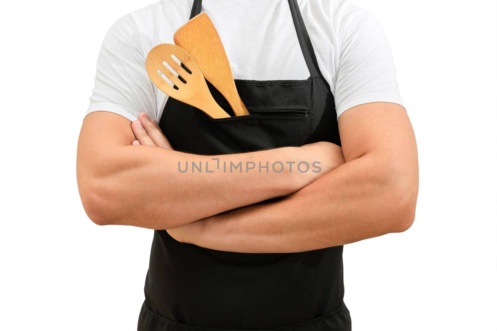 Torso of a chefs in a black apron with crossed arms isolated on a white background. Cooking concept by Shablovskyistock