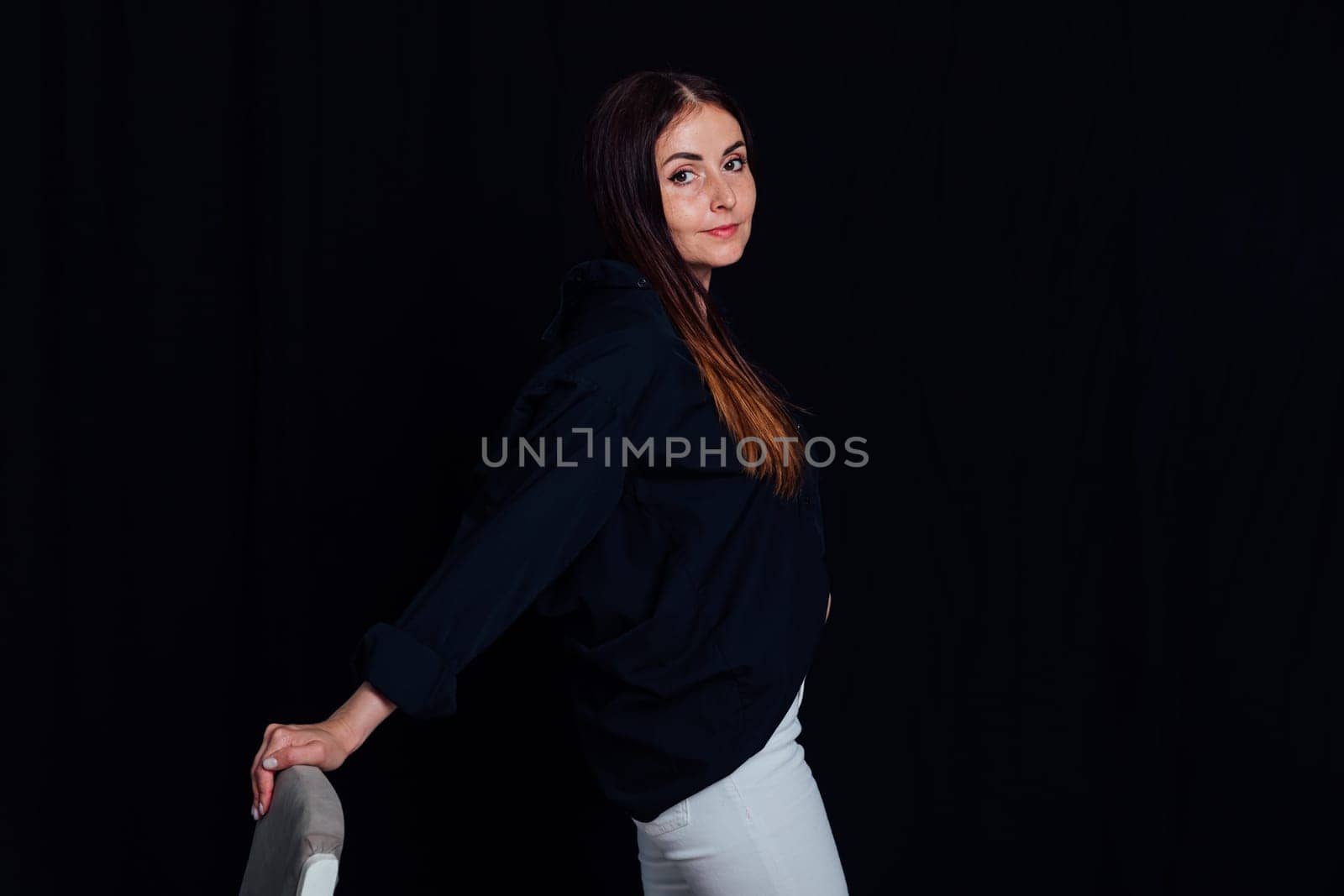 Portrait of beautiful woman in white pants and black shirt