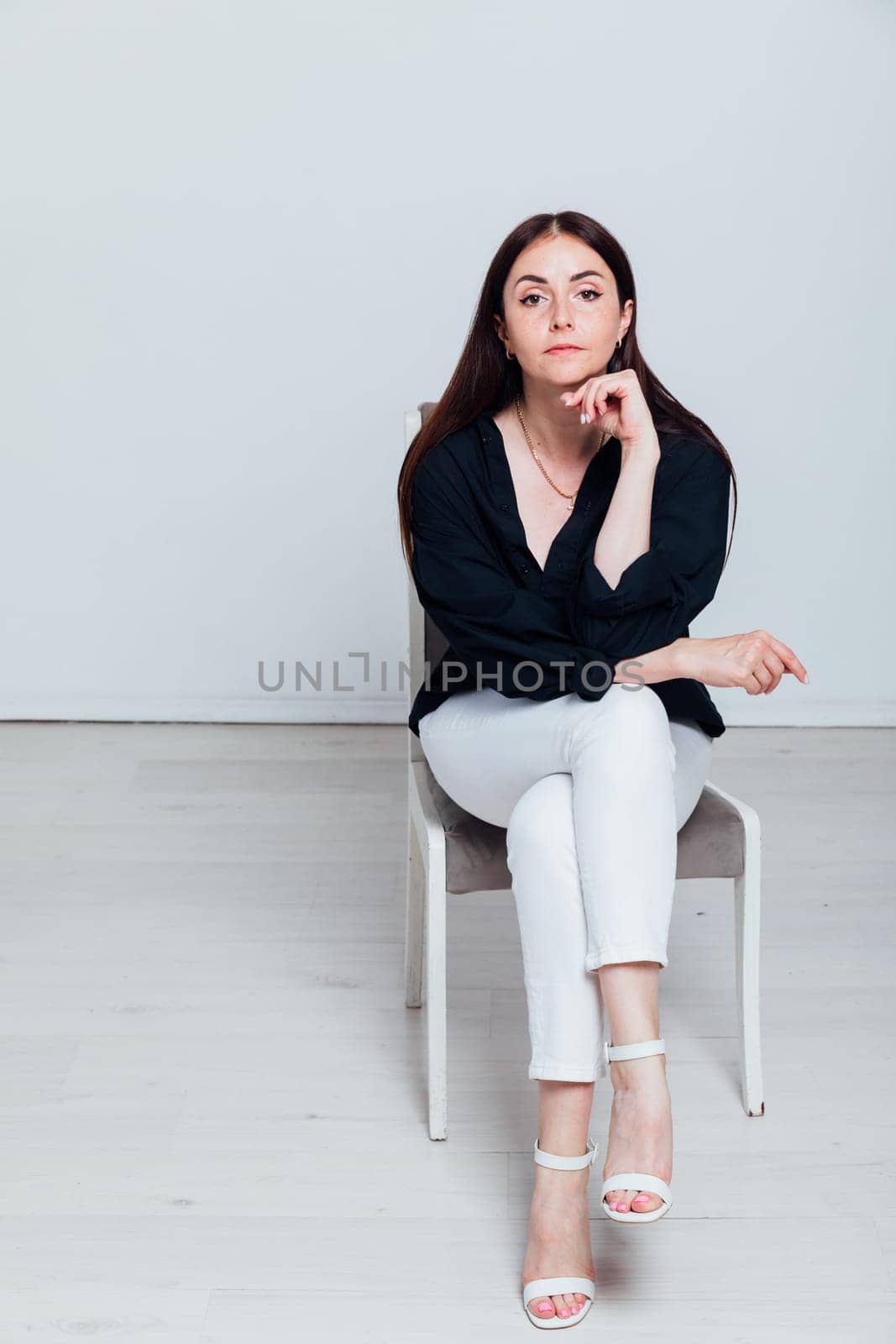 Portrait of beautiful woman in white pants and black shirt